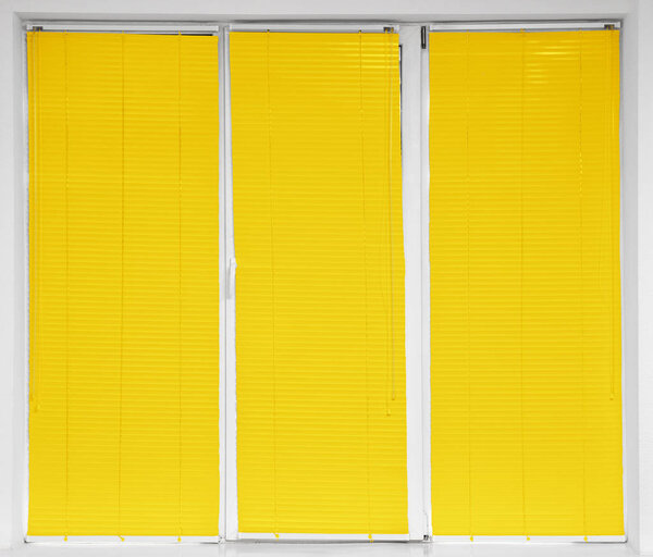 Modern window with closed stylish yellow blinds