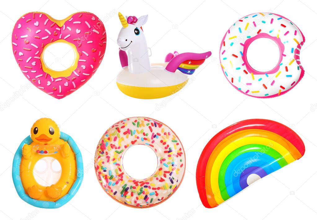 Set of bright inflatable rings and mattress on white background 