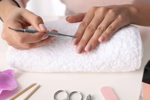 Woman preparing fingernail cuticles at table, closeup. At-home manicure — 스톡 사진