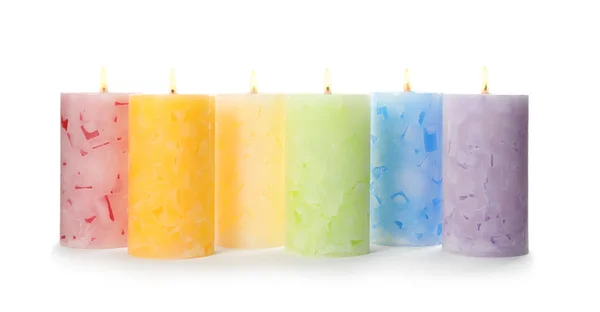 Alight color wax candles on white background — Stock Photo, Image