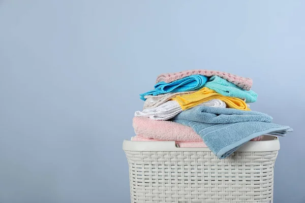 Wasserette mand met schone handdoeken op kleur achtergrond. Ruimte voor tekst — Stockfoto