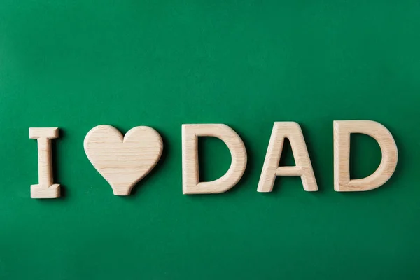 Phrase I LOVE DAD made of wooden letters on color background, top view — Stock Photo, Image