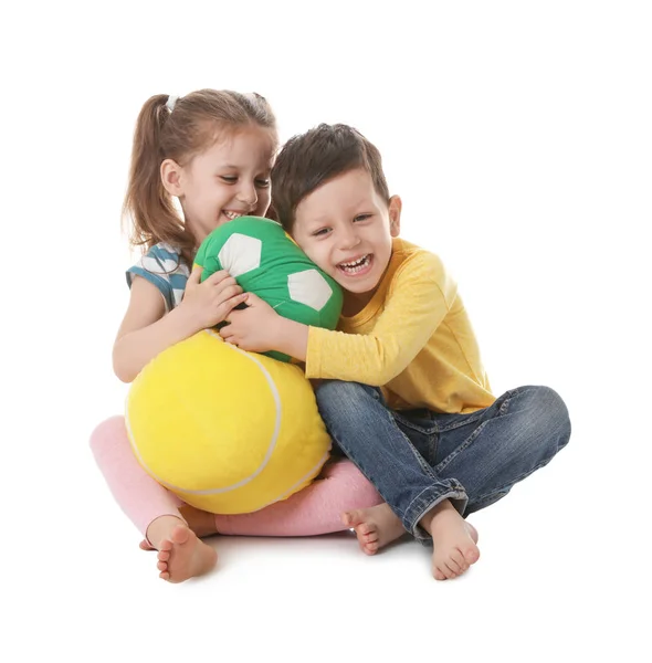 Cute little boy and girl with soft balls on white background Royalty Free Stock Images