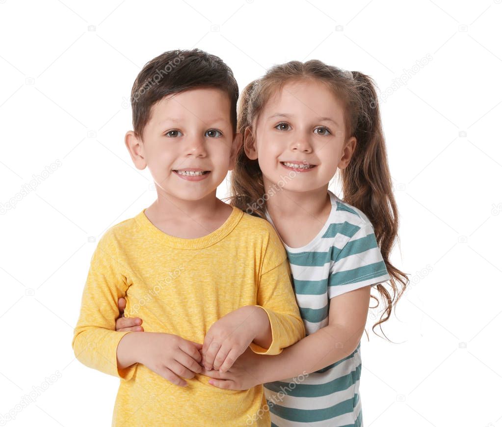 Cute little boy and girl hugging on white background