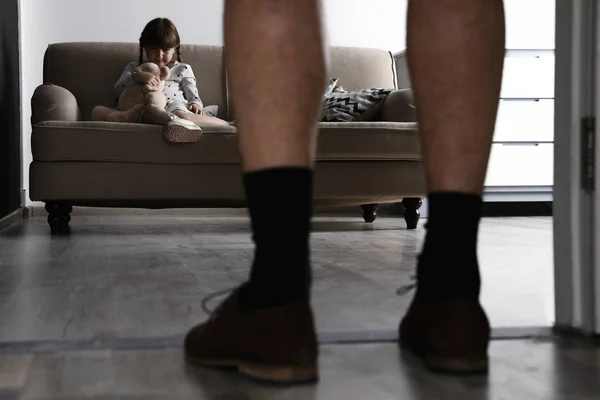 Adult man without pants standing in front of scared little girl indoors. Child in danger — Stock Photo, Image