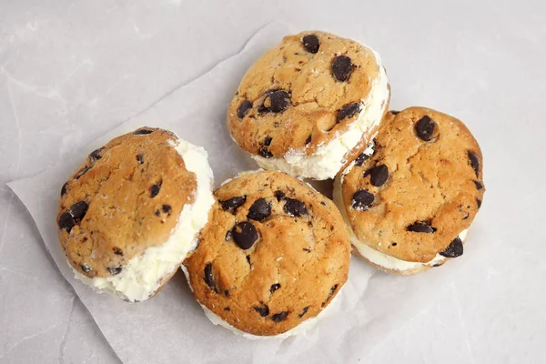 Sweet delicious ice cream cookie sandwiches on table, above view