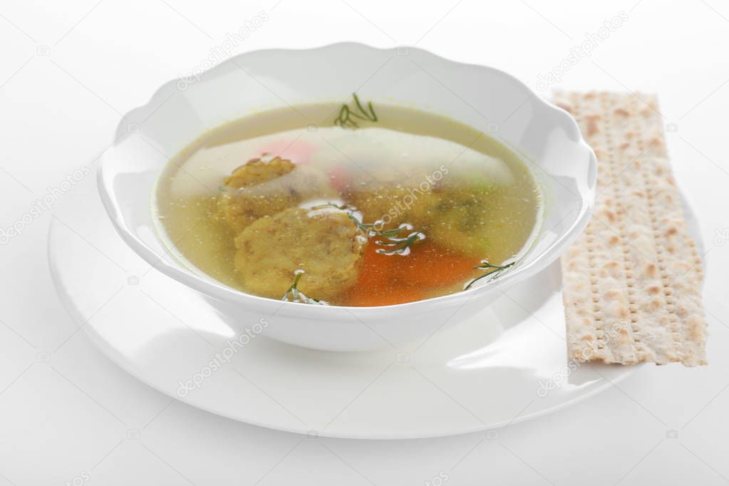 Bowl of Jewish matzoh balls soup isolated on white