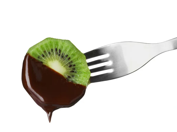 Kiwi com chocolate em garfo de fondue contra fundo branco — Fotografia de Stock