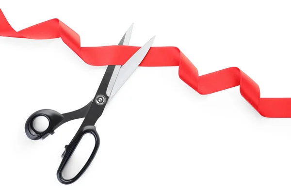 Stylish scissors and red ribbon on white background. Ceremonial tape cutting — Stock Photo, Image