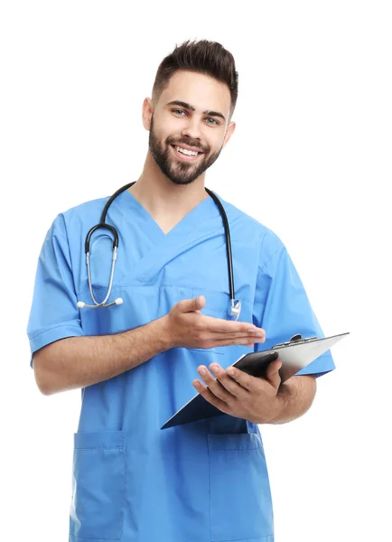 Young male doctor in uniform with clipboard isolated on white — 스톡 사진