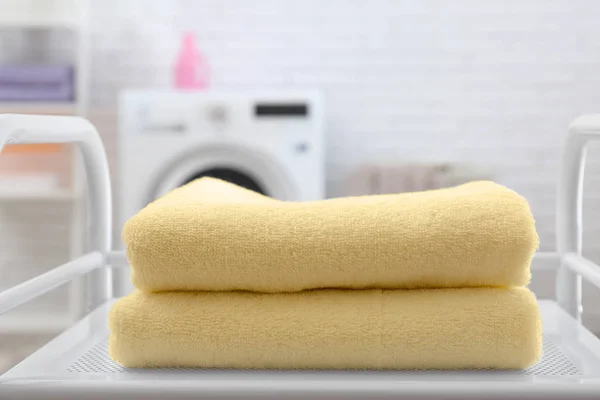 Soft terry towels on table in laundry room, closeup — Stok Foto