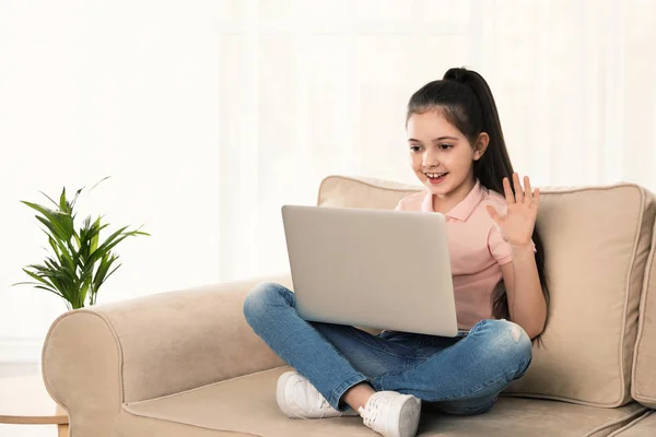 Kislány segítségével video chat a laptopon otthon — Stock Fotó