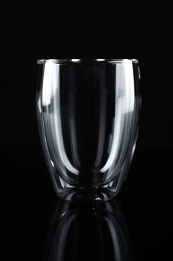 Empty double wall glass on black background clipart