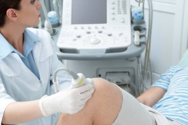 Hastanın diz iletken ultrason muayenesi kliniğinde doktor