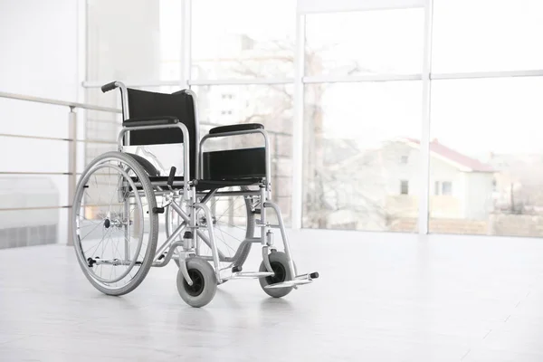 Modern wheelchair in empty room, space for text. Medical equipment — Stock Photo, Image