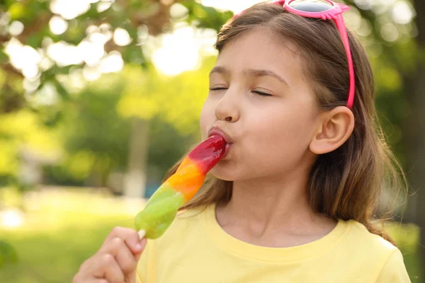 Cute little girl with delicious ice cream in park — Stock Photo, Image