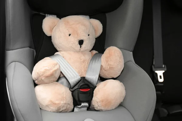 Ours en peluche dans le siège de sécurité enfant à l'intérieur de la voiture. Prévention des risques — Photo