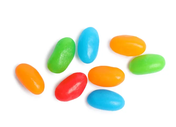 Deliciosos feijões de geleia coloridos isolados em branco, vista superior — Fotografia de Stock