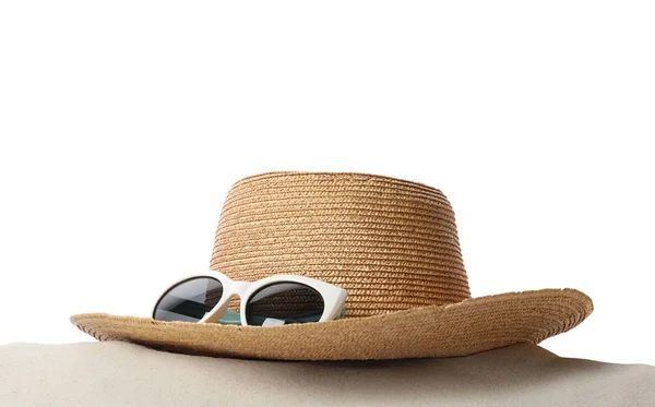 Hat and sunglasses on sand against white background. Stylish beach accessories — Stock Photo, Image