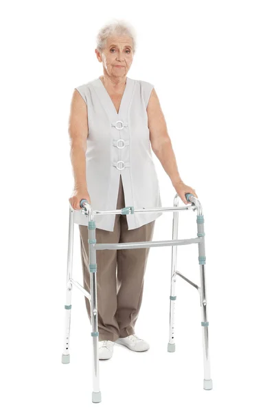 Full length portrait of elderly woman using walking frame isolated on white — Stock Photo, Image