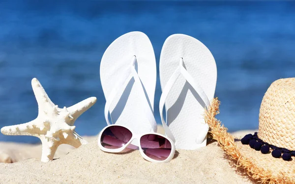Composition with beach accessories on sand near sea in summer Stock Image