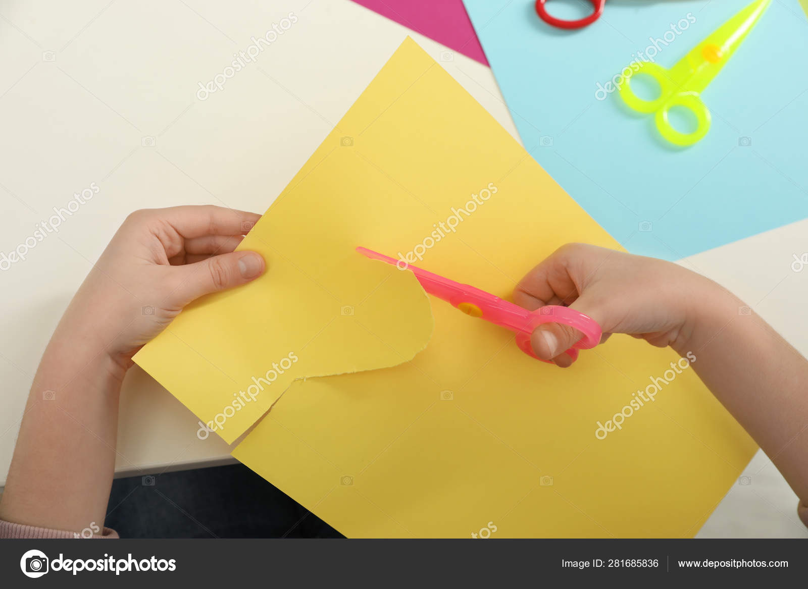 Stock Photo Child Cutting Yellow Construction Paper With Scissors