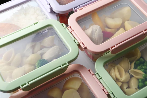 Plastic boxes with prepared meal on table