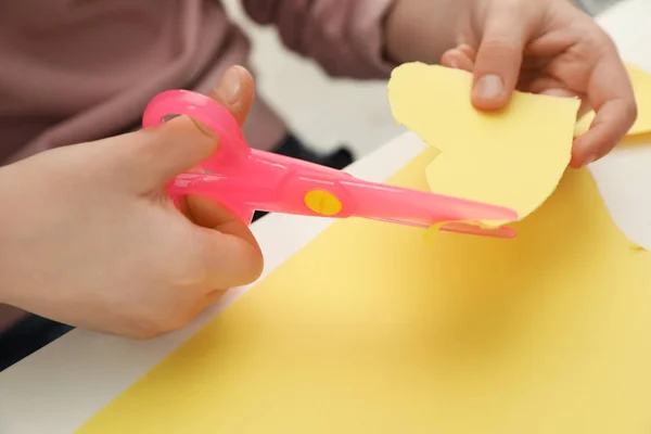 Gyerek vágókés papírszív műanyag ollóval az asztalnál, Vértes — Stock Fotó
