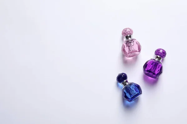 Composition with bottles of perfume on white background, top view — Stock Photo, Image