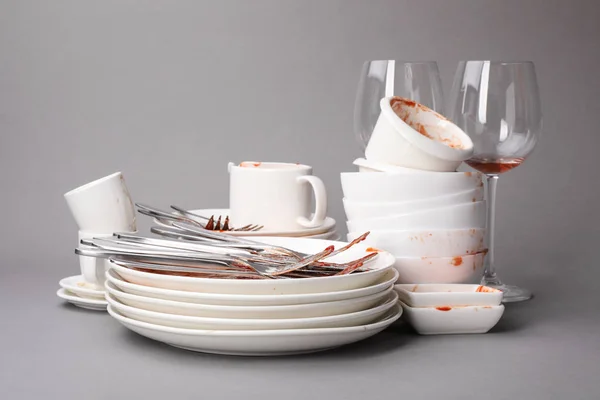 Set of dirty dishes on grey background — Stock Photo, Image