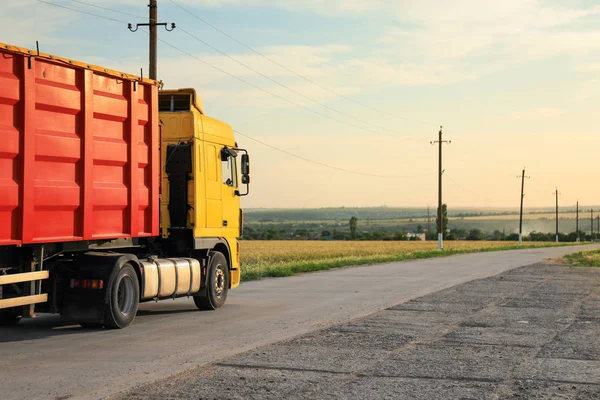 Modern truck on country road. Space for text