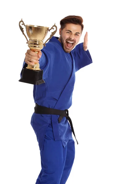 Portret van jonge emotionele man in blauwe kimono met gouden trofee Cup op witte achtergrond — Stockfoto