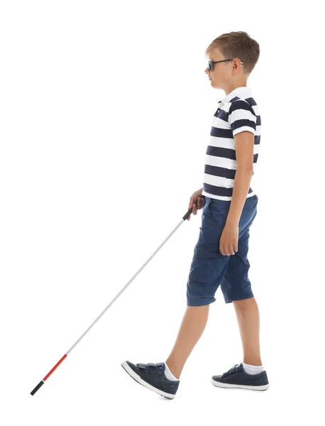 Blind boy with long cane walking on white background — Stock Photo, Image