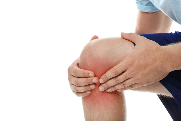 Man having knee problems on white background, closeup — Stock Photo, Image