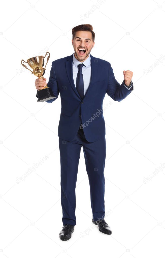 Full length portrait of happy young businessman with gold trophy cup on white background