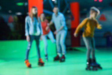 Blurred view of family at roller skating rink clipart