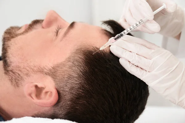 Man with hair loss problem receiving injection in salon — Stock Photo, Image