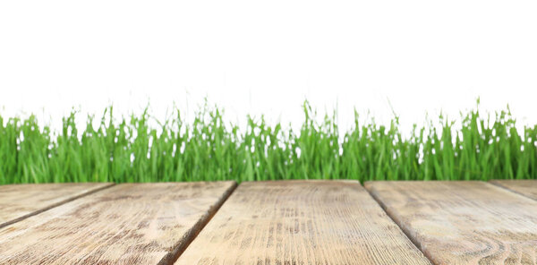 Wooden deck and green grass isolated on white