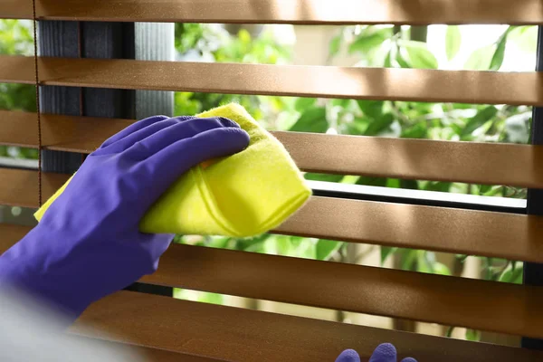 Janitor wiping window blinds with rag indoors, closeup. Space for text — Stock Photo, Image