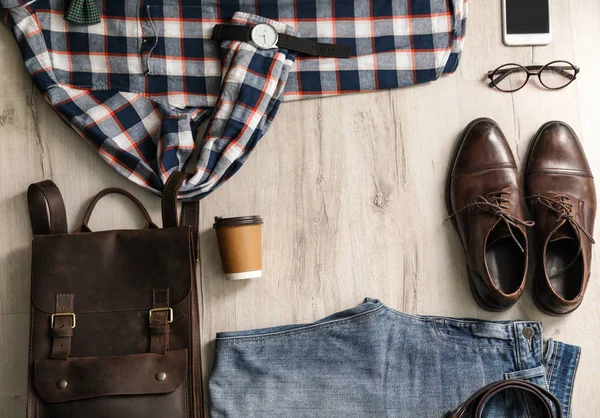 Flat lay composition with male outfit and accessories on wooden floor. Space for text — Stock Photo, Image