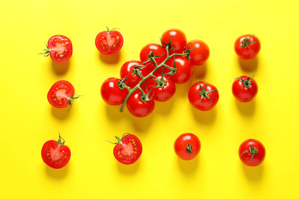 Flat lay composition with ripe cherry tomatoes on color background