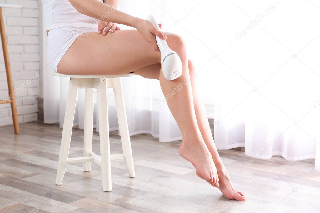 Woman doing leg epilation procedure indoors, closeup