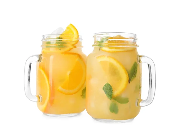 Mason jars with orange refreshing drink on white background — Stock Photo, Image