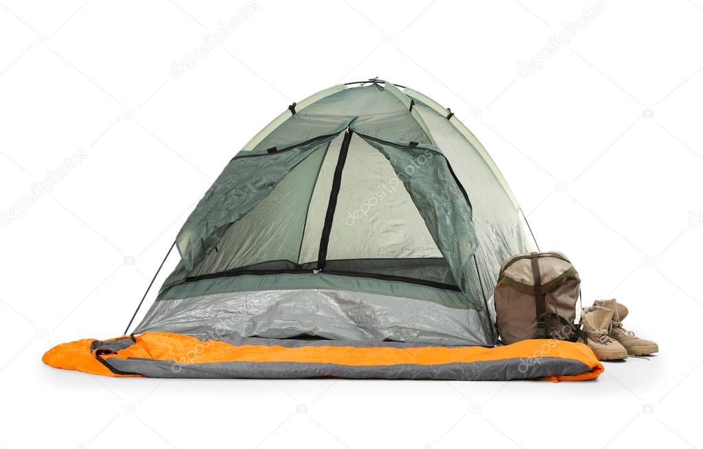 Comfortable grey camping tent with sleeping bag and boots on white background