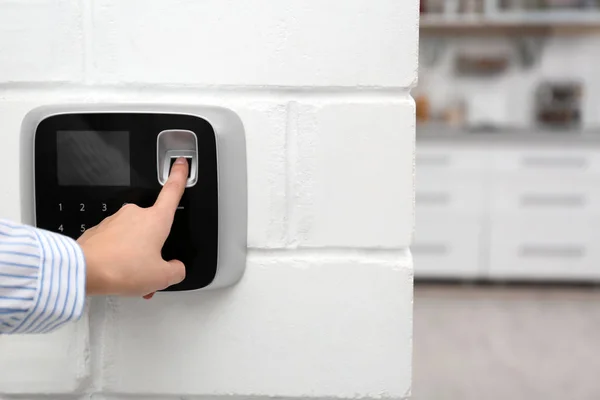 Woman scanning fingerprint on alarm system at home, closeup. Space for text — Stock Photo, Image