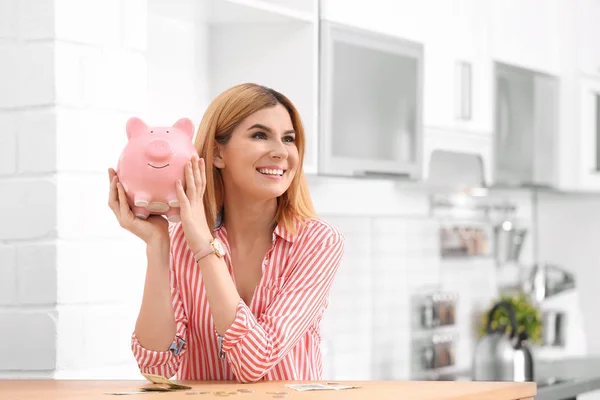 Woman with piggy bank and money at home. Space for text — Stock Photo, Image