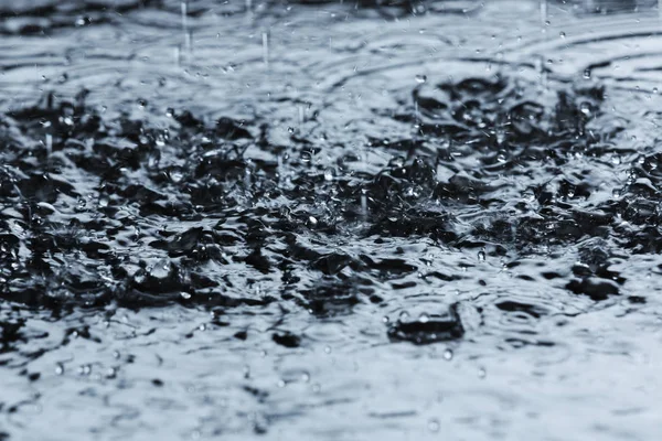 Chuva pesada caindo na poça ao ar livre — Fotografia de Stock