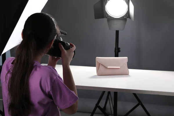 Fotógrafo profesional disparando bolso con estilo en estudio — Foto de Stock