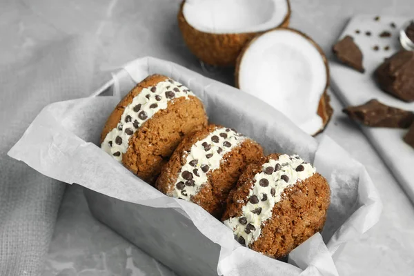 Sweet delicious ice cream cookie sandwiches with chocolate chips served on table