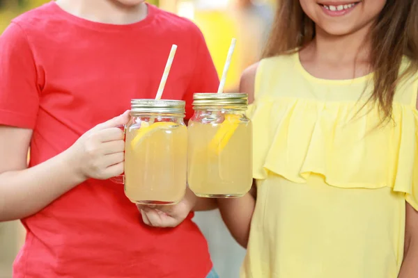 Little girls with natural lemonade, closeup. Summer refreshing drink — Stock Photo, Image